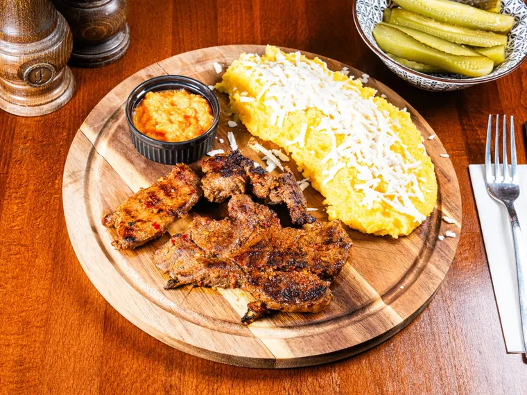 A plate of pastramă de berbecuț (cured and grilled young mutton), at Ciorbe La Ion