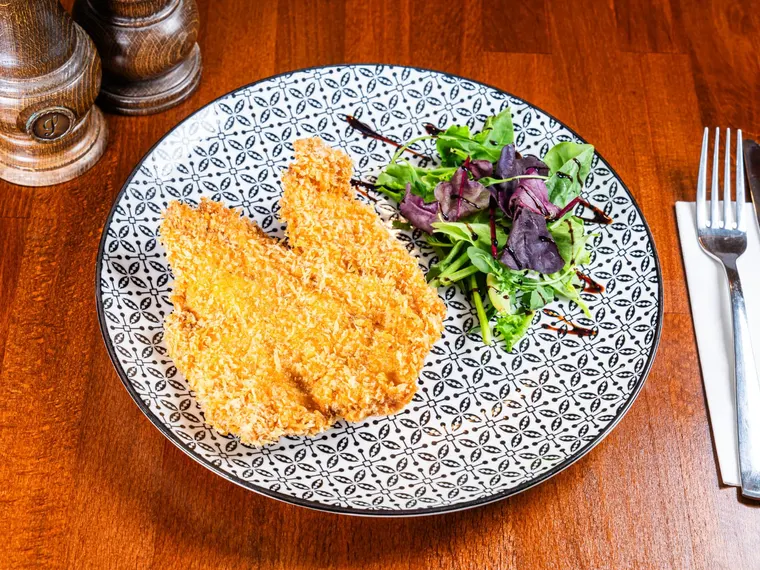 A plate of șnițel (breaded schnitzel, our own recipe), at Ciorbe La Ion