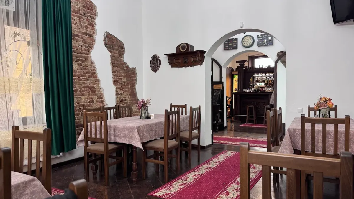 The dining room with the tables laid, and the bar seen through the archway